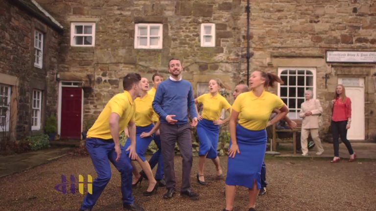 Hampson Hughes TV advert: dancers in a village square