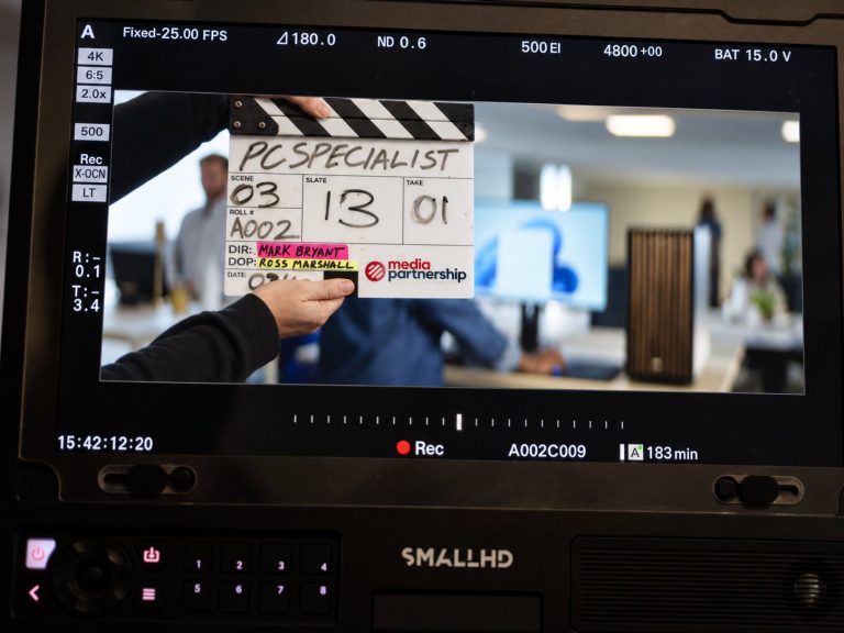 A clapperboard for a PC Specialist TV advert shown on a camera monitor